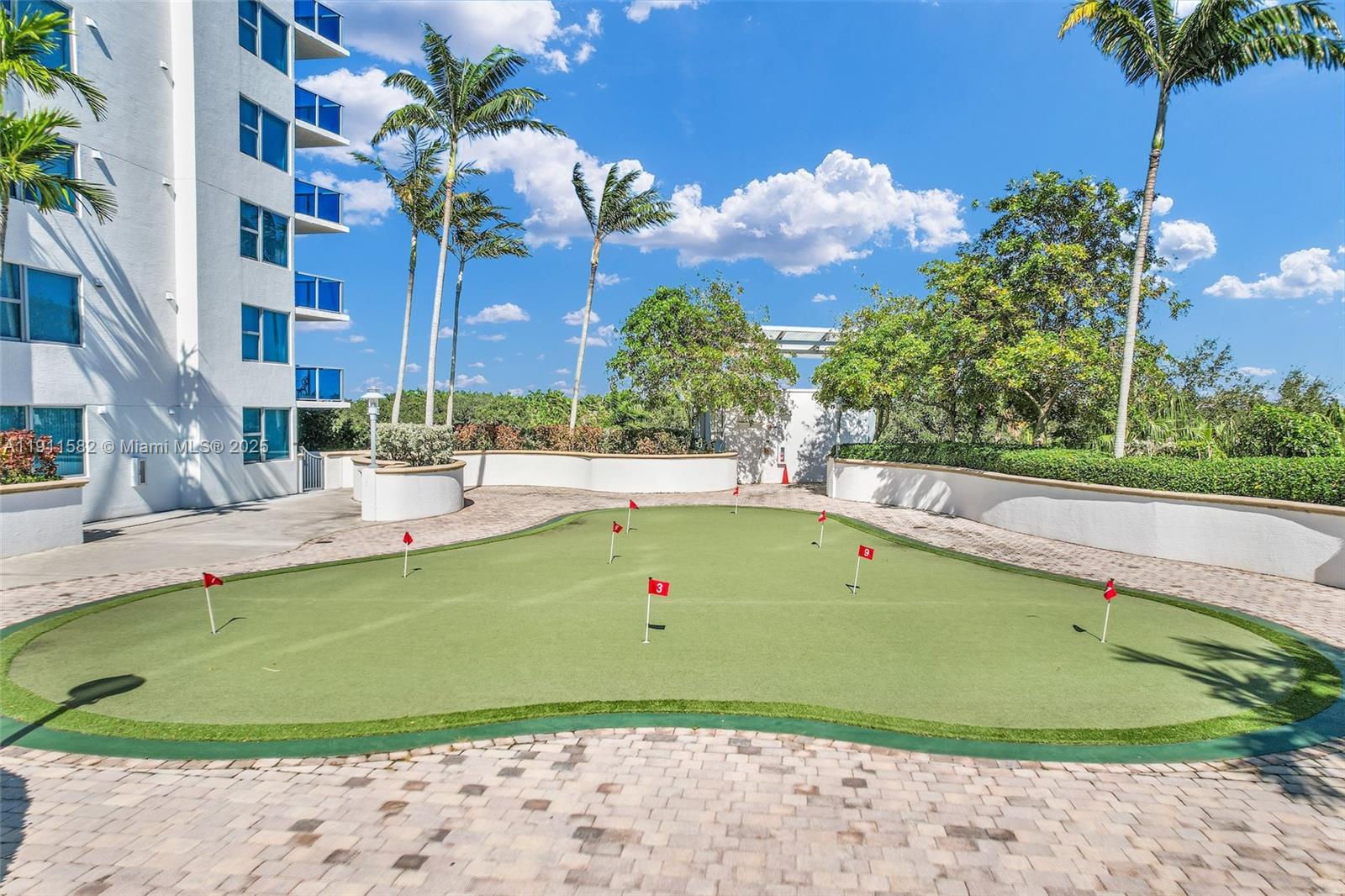 2681 North Flamingo Road, Unit 1903S Sunrise, FL 33323 - Photo 55 of 55 a view of a swimming pool with a lawn chairs under an umbrella
