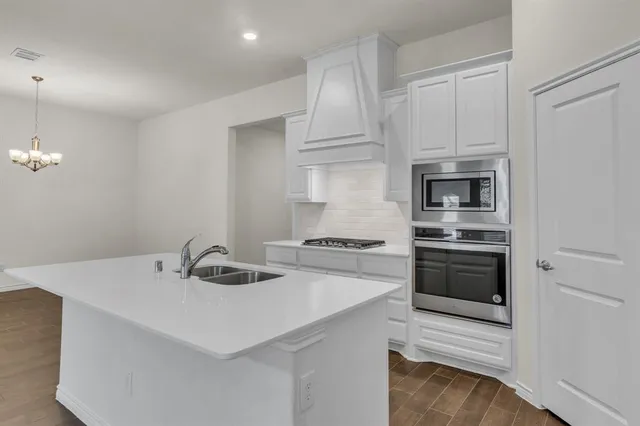 a kitchen with a sink a stove and refrigerator