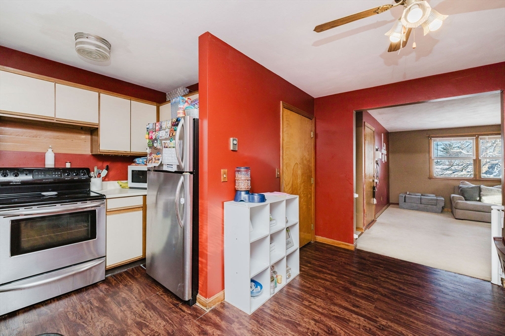 195 Crescent Street, Unit 3 Fall River, MA 02720 - Photo 14 of 34 a kitchen with stainless steel appliances wooden floor and a refrigerator