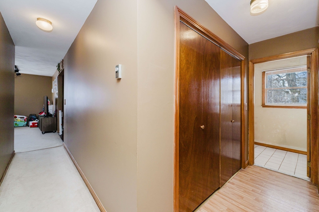 195 Crescent Street, Unit 3 Fall River, MA 02720 - Photo 17 of 34 a view of a hallway with wooden shelves