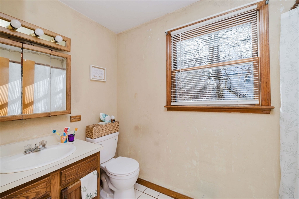 195 Crescent Street, Unit 3 Fall River, MA 02720 - Photo 20 of 34 a bathroom with a sink a toilet and a window