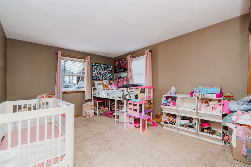 195 Crescent Street, Unit 3 Fall River, MA 02720 - Photo 21 of 34 a bedroom with furniture a baby crib and a window