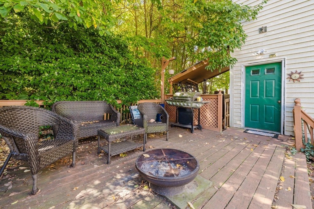 195 Crescent Street, Unit 3 Fall River, MA 02720 - Photo 31 of 34 a view of a patio with table and chairs potted plants and a large tree