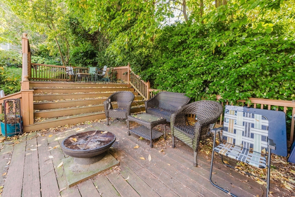 195 Crescent Street, Unit 3 Fall River, MA 02720 - Photo 32 of 34 a view of a patio with table and chairs with wooden floor and fence