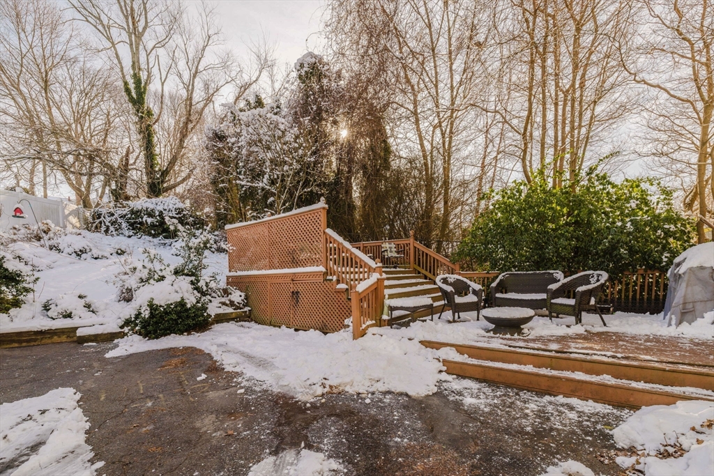 195 Crescent Street, Unit 3 Fall River, MA 02720 - Photo 34 of 34 a view of a patio with a table and chairs under a large tree