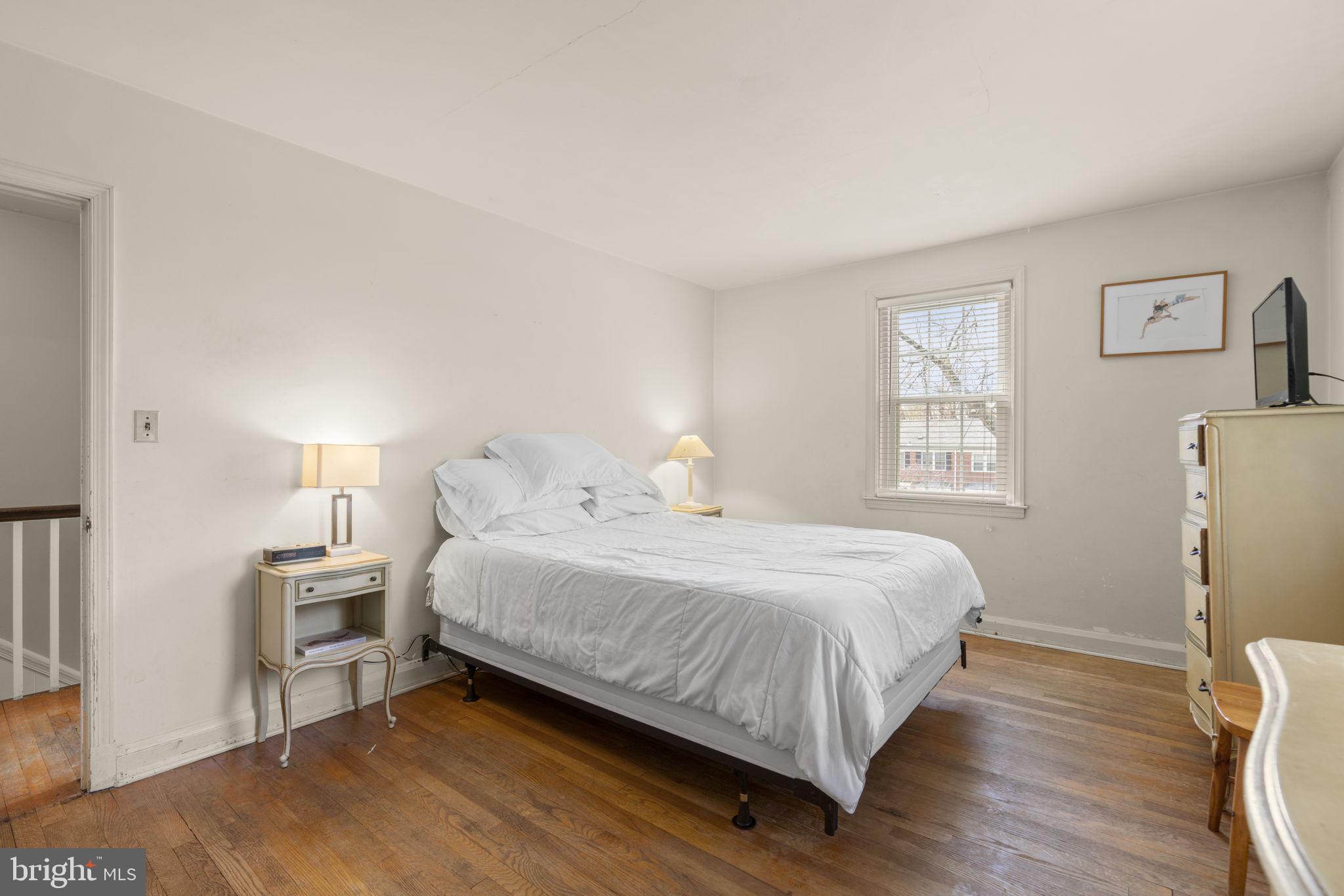 7413 Stanmore Court Baltimore, MD 21212 - Photo 16 of 38 a bedroom with a bed and wooden floor