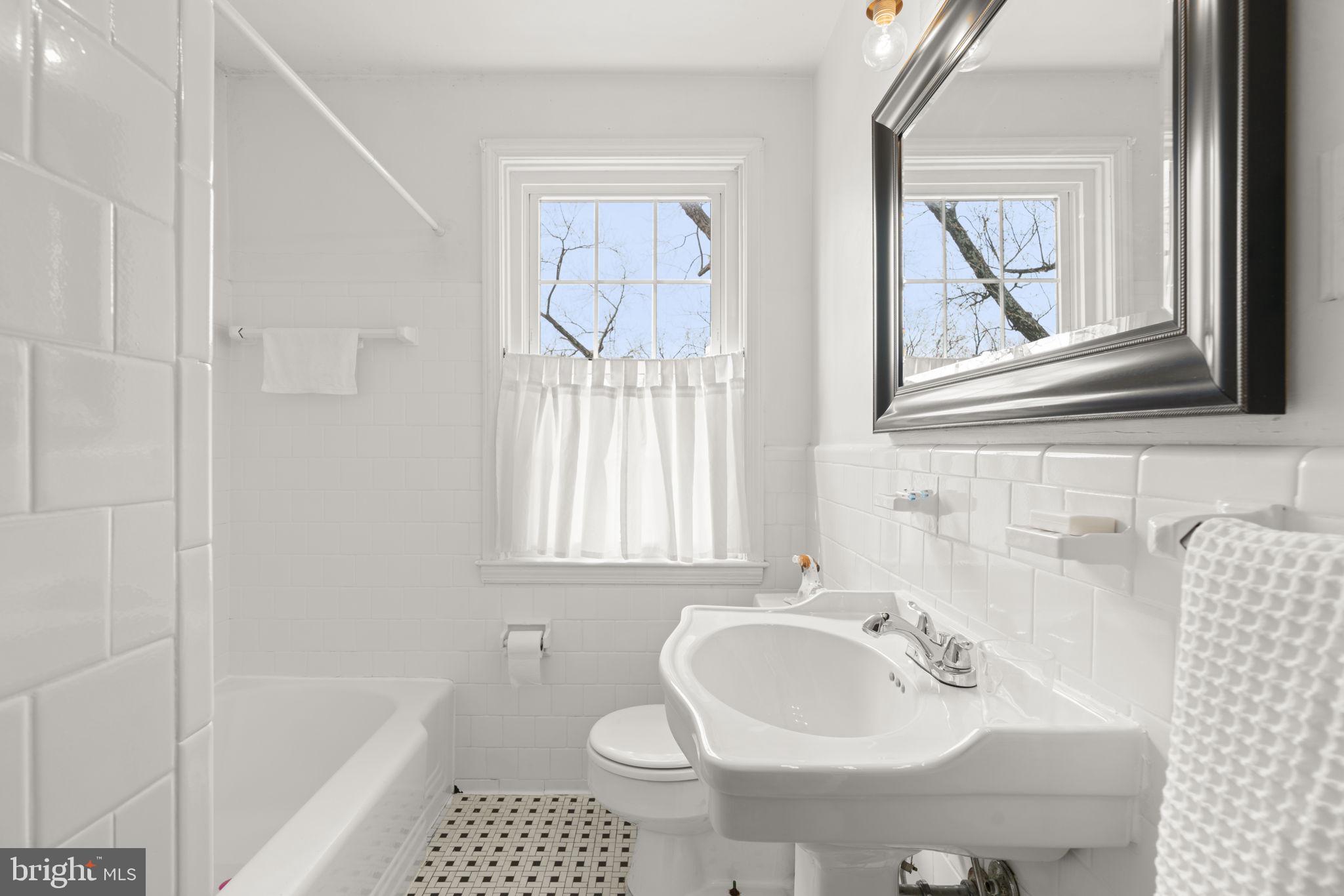 7413 Stanmore Court Baltimore, MD 21212 - Photo 19 of 38 a bathroom with a sink and a bathtub