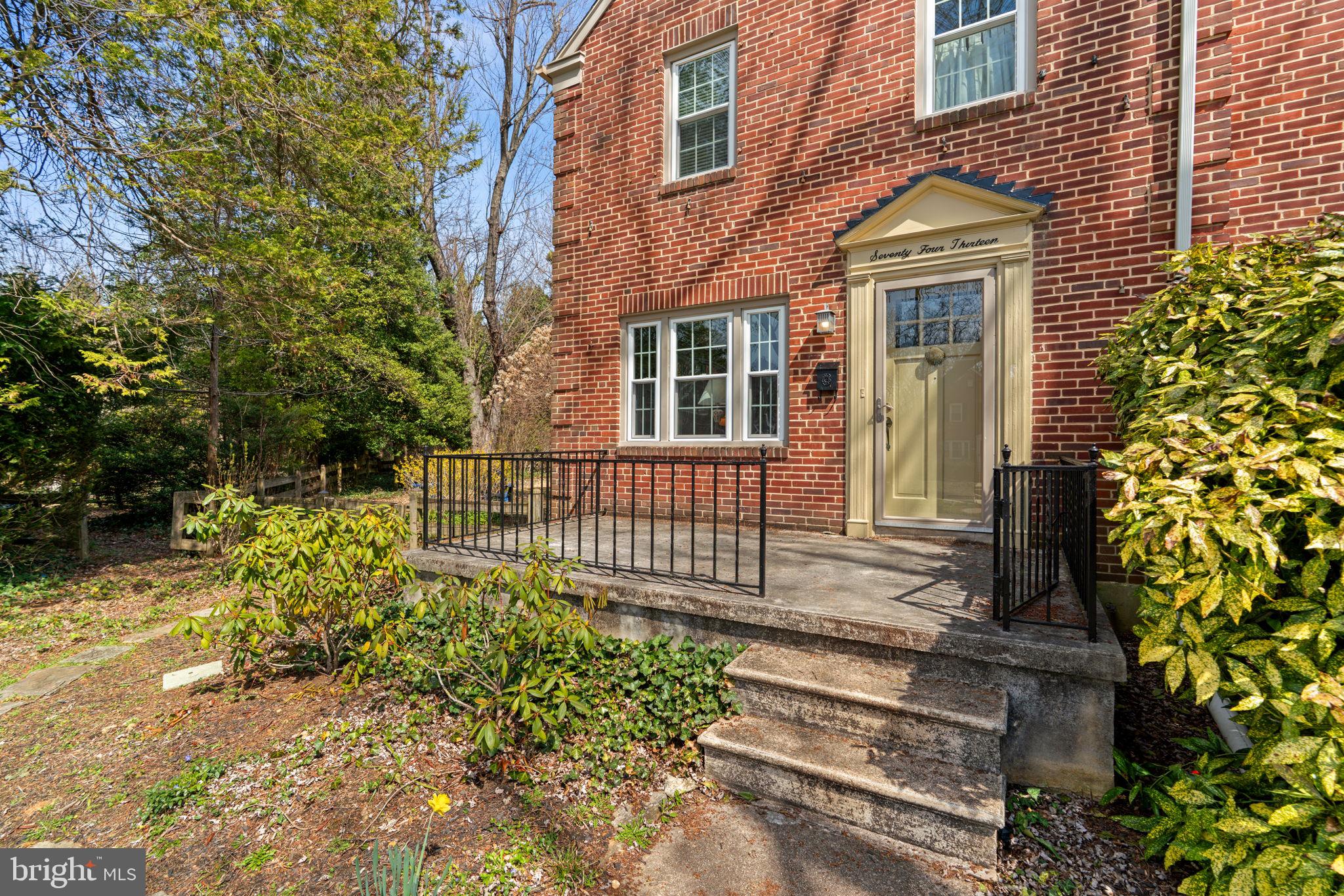 7413 Stanmore Court Baltimore, MD 21212 - Photo 4 of 38 a front view of a house with a garden