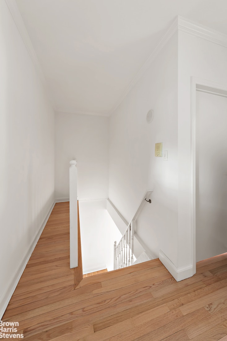 a view of hallway with wooden floor
