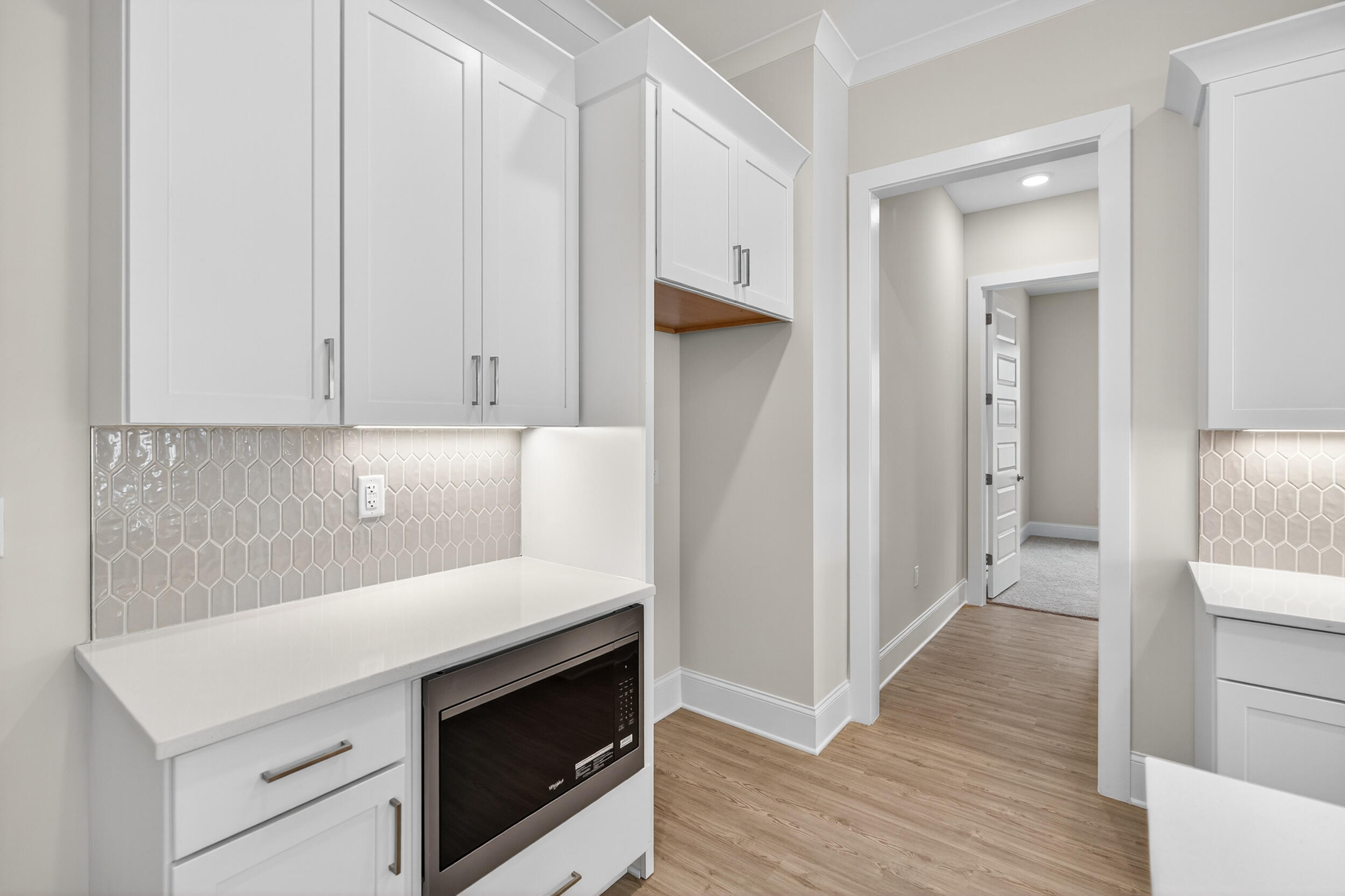 19 North J Hunter's Way, Unit LOT 22 Freeport, FL 32439 - Photo 13 of 48 a view of a kitchen with cabinets and wooden floor