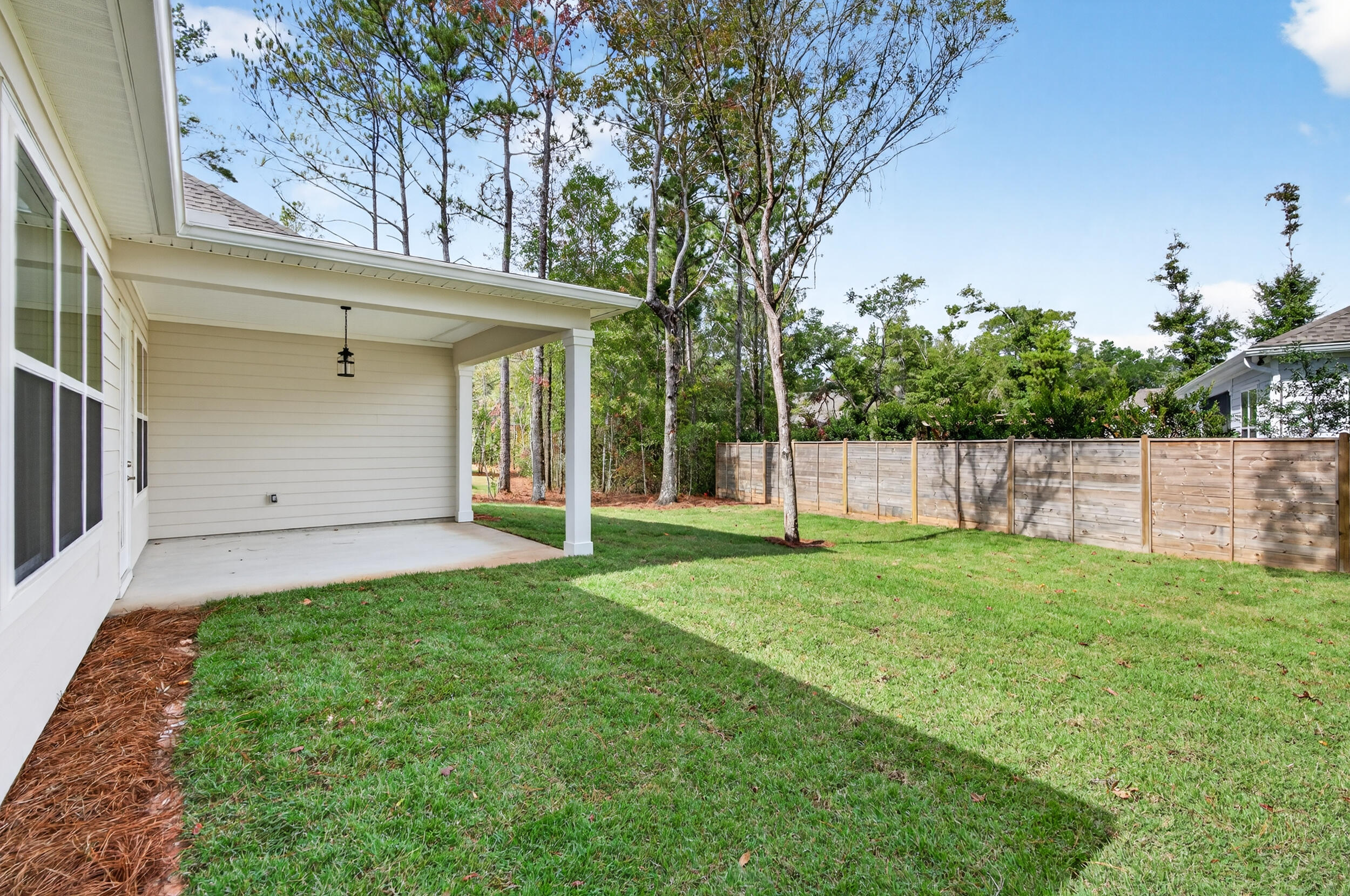 19 North J Hunter's Way, Unit LOT 22 Freeport, FL 32439 - Photo 33 of 48 a view of a backyard with large trees and plants