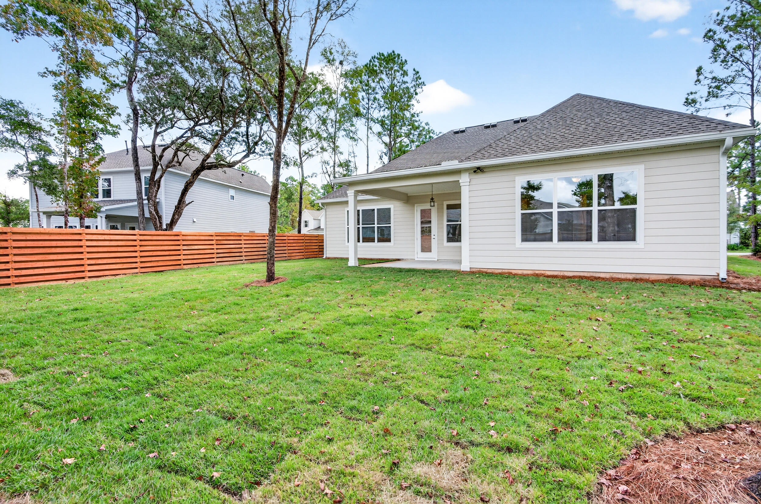 19 North J Hunter's Way, Unit LOT 22 Freeport, FL 32439 - Photo 36 of 48 a view of a house with yard and tree s
