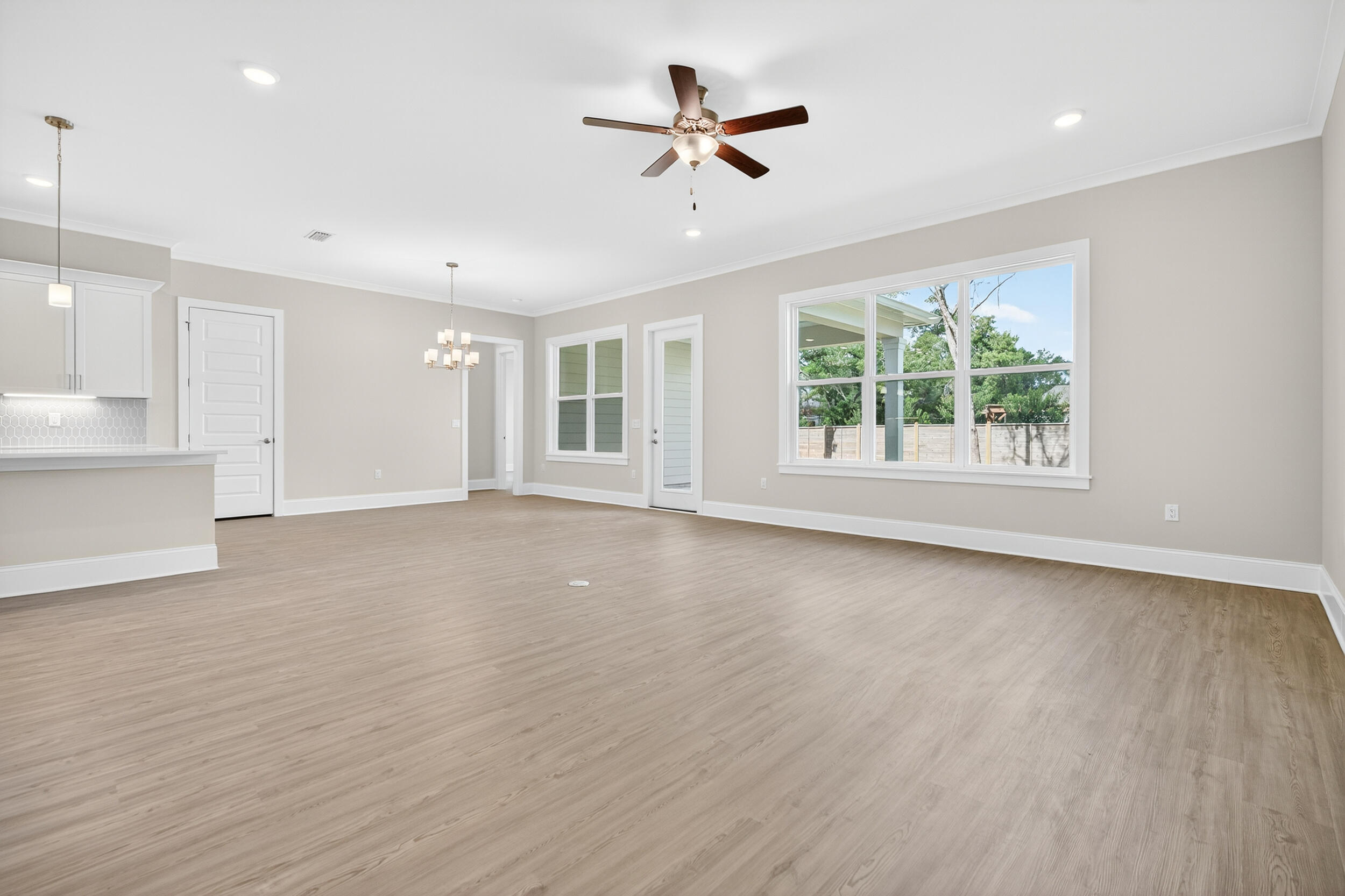 19 North J Hunter's Way, Unit LOT 22 Freeport, FL 32439 - Photo 9 of 48 an empty room with wooden floor and windows