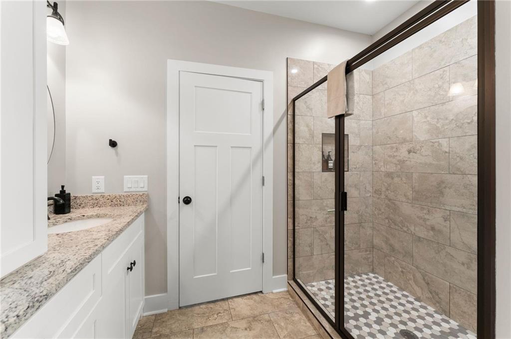 1320 Preacher Campbell Road Clarkesville, GA 30523 - Photo 15 of 36 a bathroom with a granite countertop shower sink and mirror