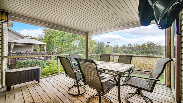 a view of a porch with furniture and a yard