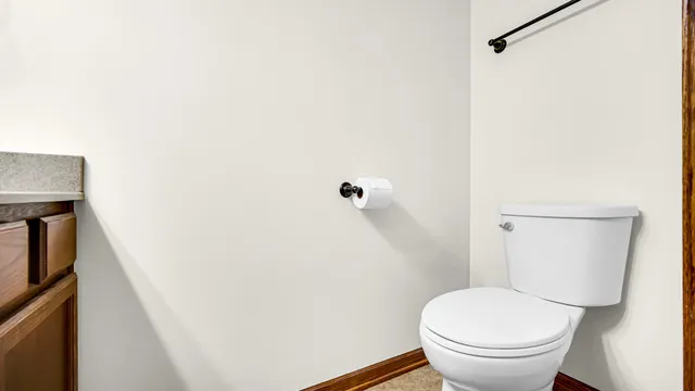 a white toilet sitting next to a shower