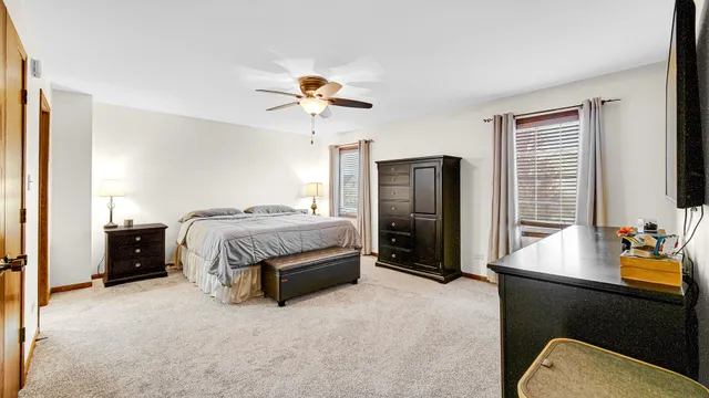 a bedroom with a bed dresser and a window