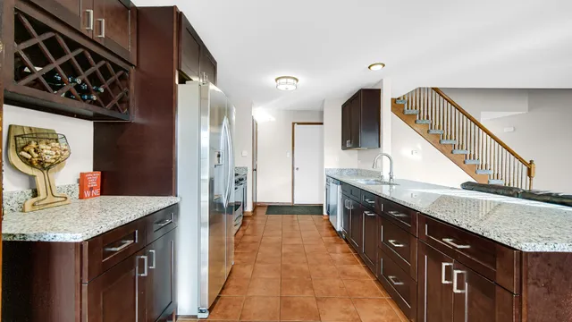 a spacious bathroom with a granite countertop double vanity sink and a mirror
