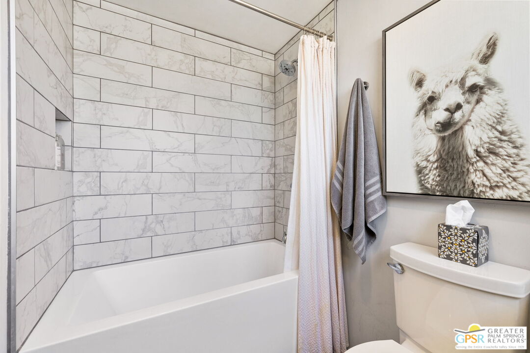 2267 North San Antonio Road Palm Springs, CA 92262 - Photo 16 of 40 a bathroom with a shower a toilet and a bathtub