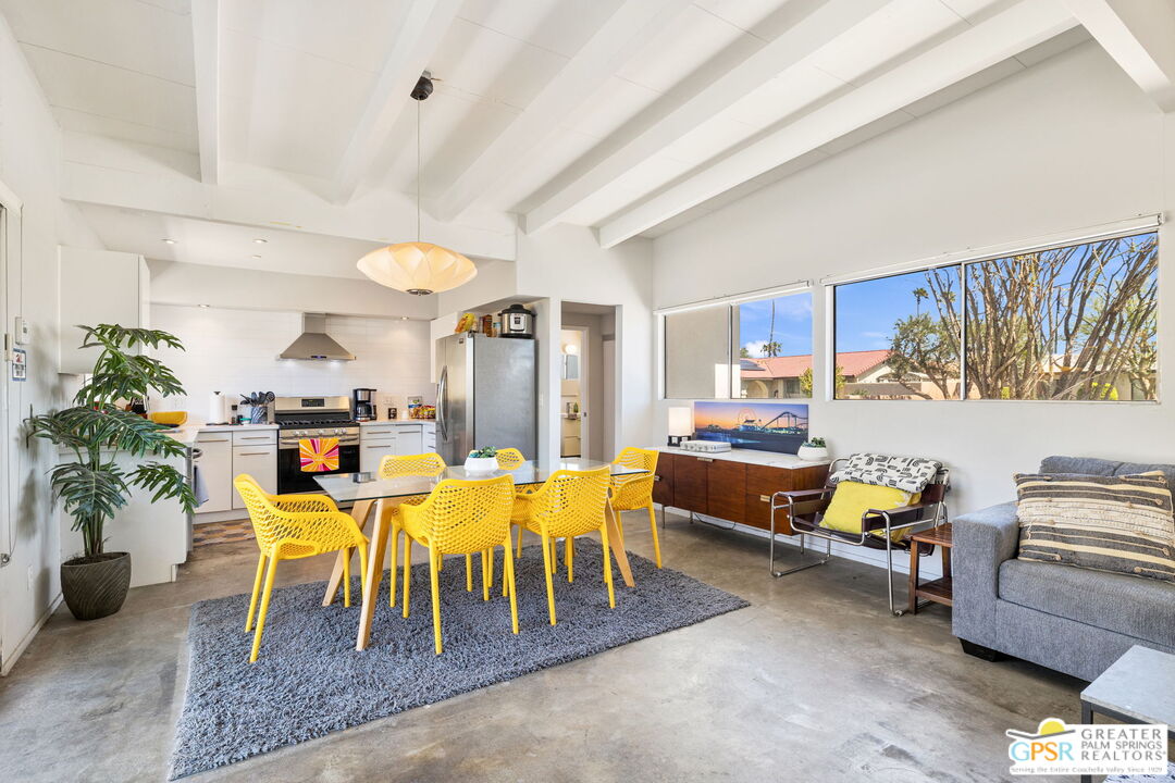 2267 North San Antonio Road Palm Springs, CA 92262 - Photo 18 of 40 a living room with furniture and a dining table with potted plants