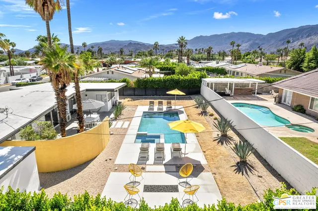 a view of a swimming pool and lounge chairs