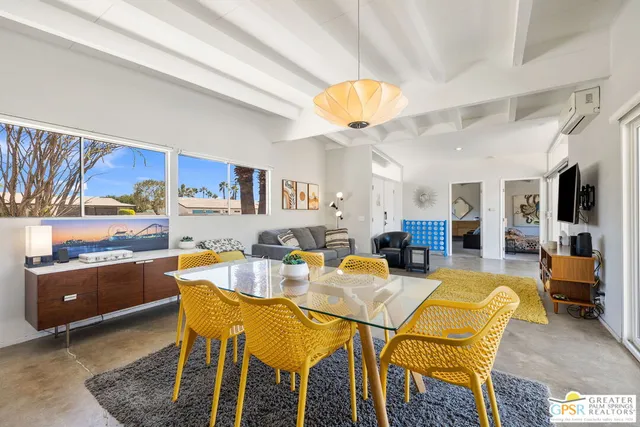 a dining room with furniture and a kitchen view