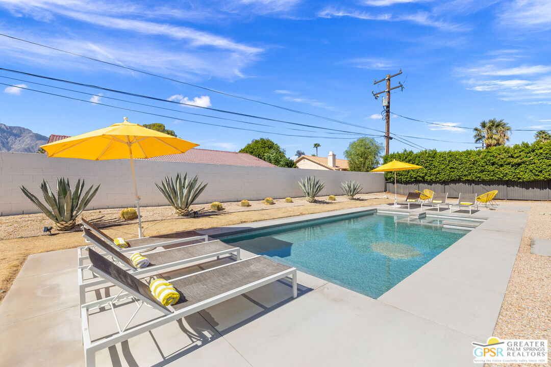 2267 North San Antonio Road Palm Springs, CA 92262 - Photo 34 of 40 a view of a swimming pool with a patio and a yard