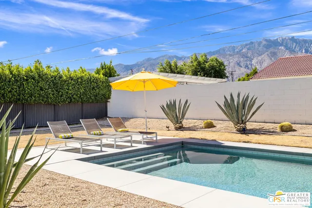 a view of a swimming pool with a lounge chair
