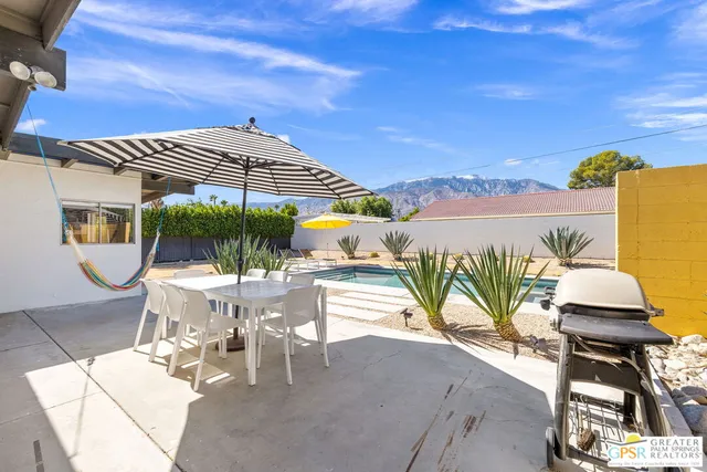 an outdoor space with furniture and umbrella