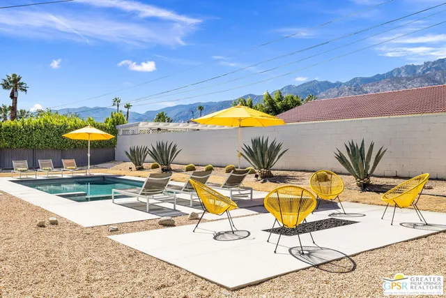 a view of a swimming pool with lounge chairs