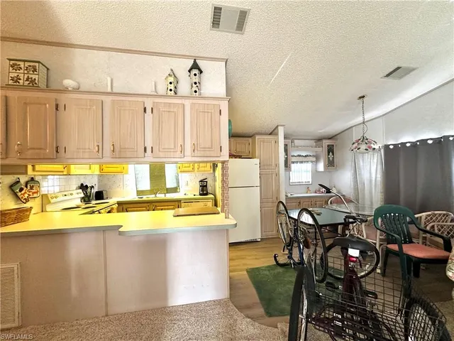 a utility room with dryer washer and a view of living room