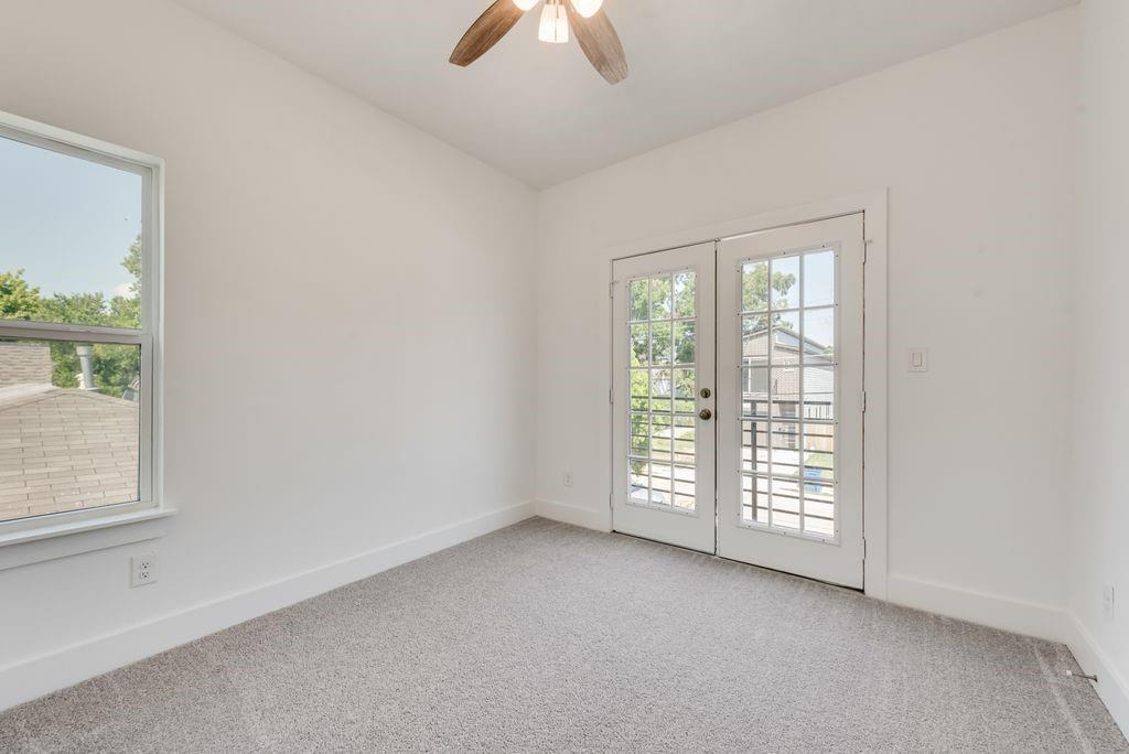 2346 Scott Street Dallas, TX 75215 - Photo 11 of 20 an empty room with windows and chandelier fan