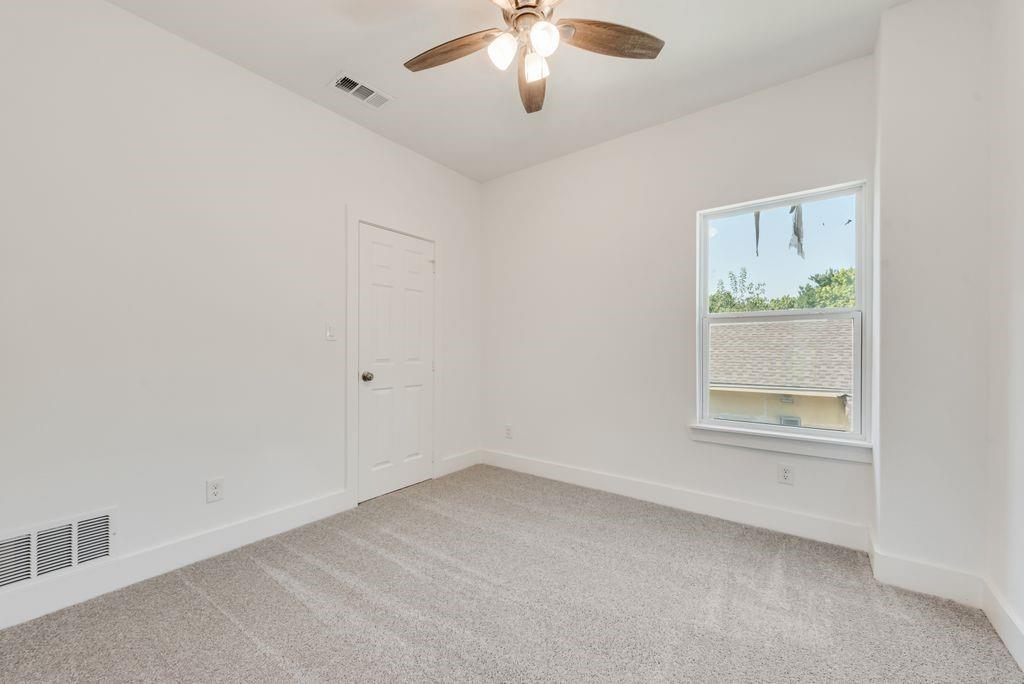 2346 Scott Street Dallas, TX 75215 - Photo 13 of 20 an empty room with a window and a ceiling fan