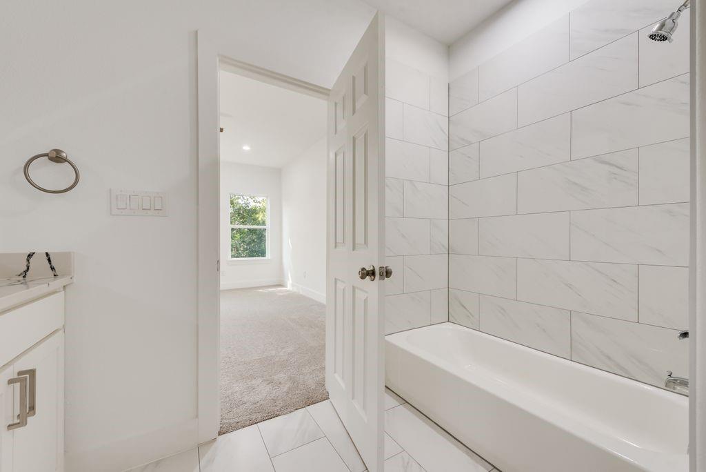 2346 Scott Street Dallas, TX 75215 - Photo 17 of 20 a bathroom with a bathtub and shower