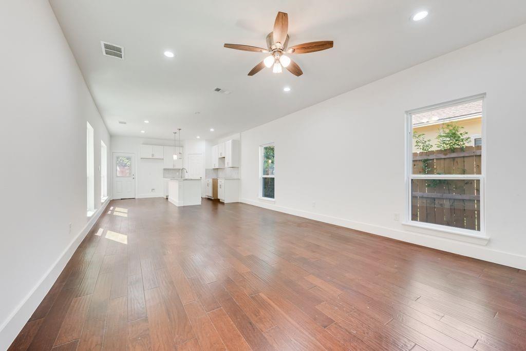 2346 Scott Street Dallas, TX 75215 - Photo 5 of 20 a view of an empty room with a window and wooden floor