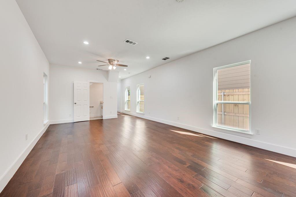 2346 Scott Street Dallas, TX 75215 - Photo 6 of 20 an empty room with wooden floor and windows