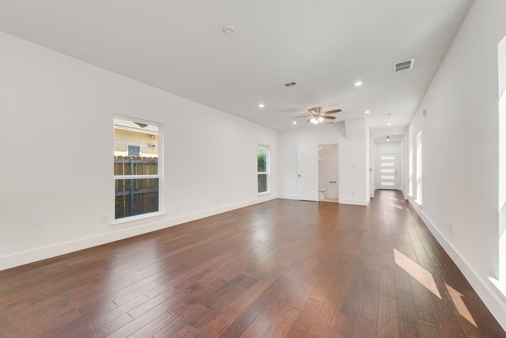 2346 Scott Street Dallas, TX 75215 - Photo 7 of 20 a view of an empty room with wooden floor and a window