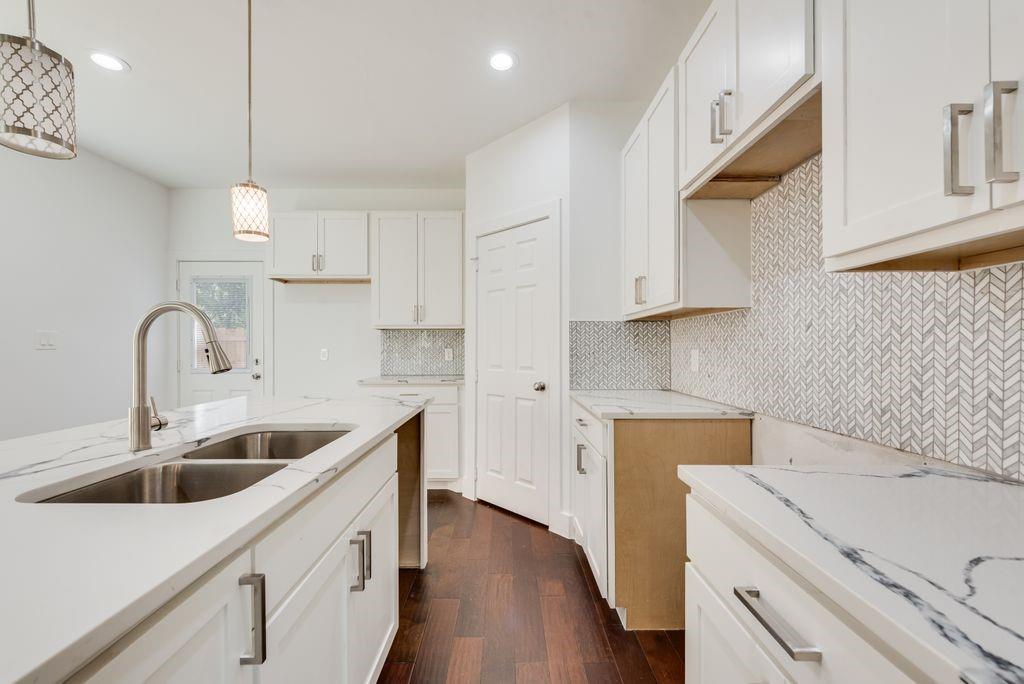 2346 Scott Street Dallas, TX 75215 - Photo 9 of 20 a kitchen with sink cabinets and wooden floor