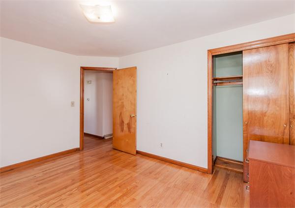 237 Carver Street Springfield, MA 01108 - Photo 13 of 25 an empty room with wooden floor and closet