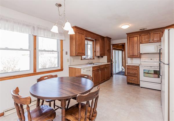 237 Carver Street Springfield, MA 01108 - Photo 7 of 25 a kitchen with stainless steel appliances a table chairs and chandelier