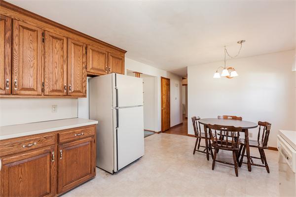 237 Carver Street Springfield, MA 01108 - Photo 9 of 25 a kitchen with refrigerator cabinets dining table and chairs