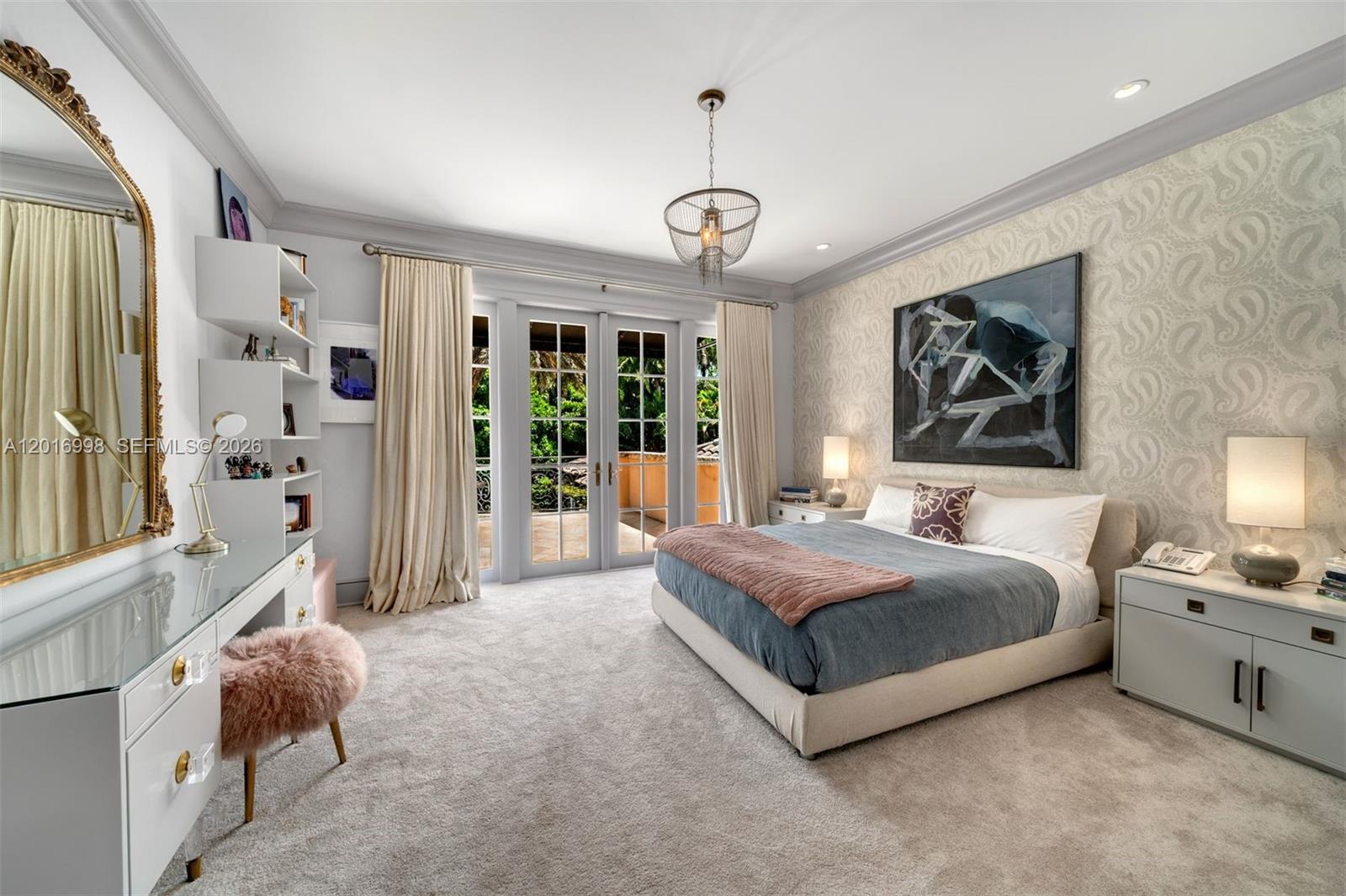 4790 Southwest 78th Street Miami, FL 33143 - Photo 22 of 33 a spacious bedroom with a bed a chandelier and a large window