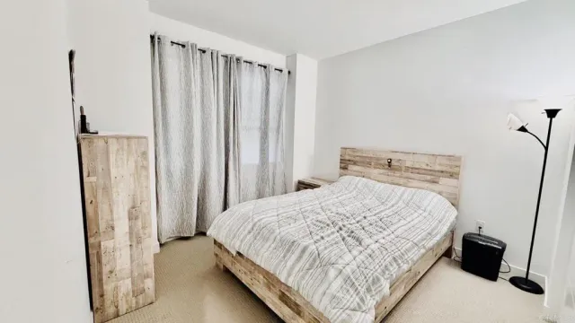a bedroom with a bed and a window