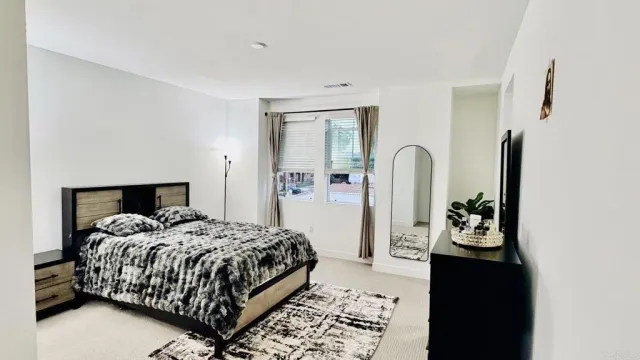 a bedroom with a bed and a window