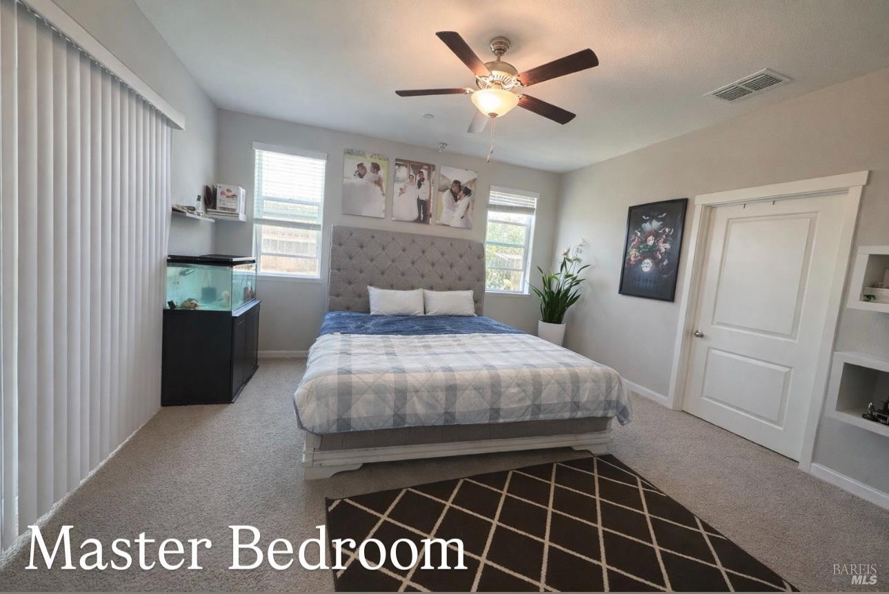 2250 Lavender Place Rio Vista, CA 94571 - Photo 5 of 13 a bedroom with a bed and a chandelier