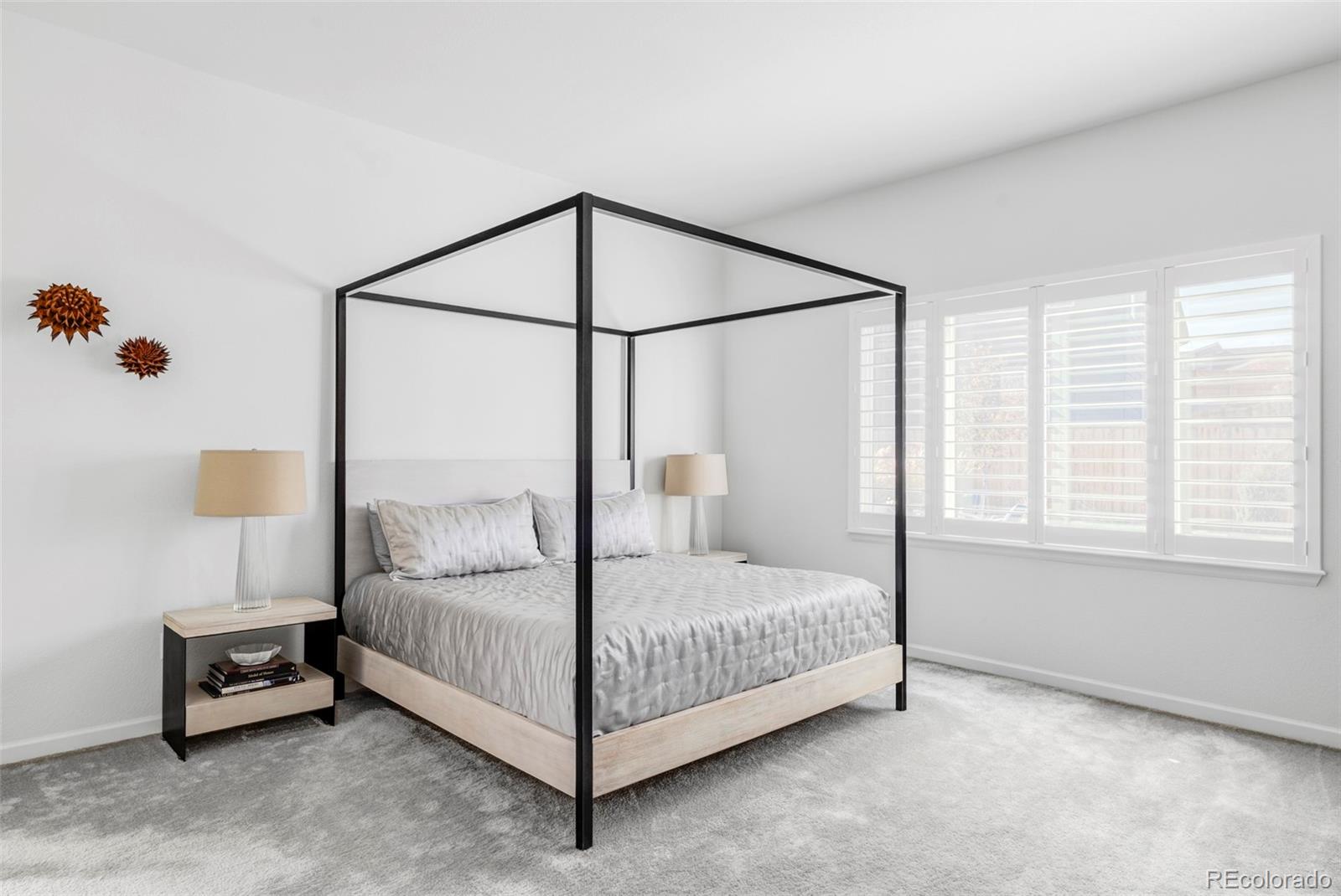 14395 Hop Clover Street Parker, CO 80134 - Photo 12 of 32 a bedroom with a bed table and a window