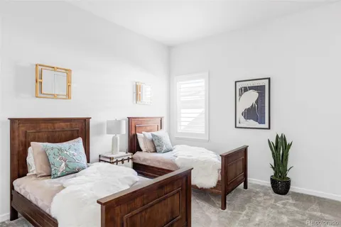 a bedroom with a bed and a potted plant