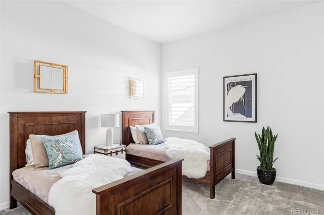 a bedroom with a bed and a potted plant