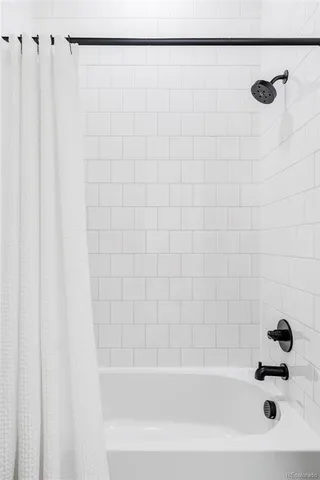 a bathroom with a shower and a bathtub