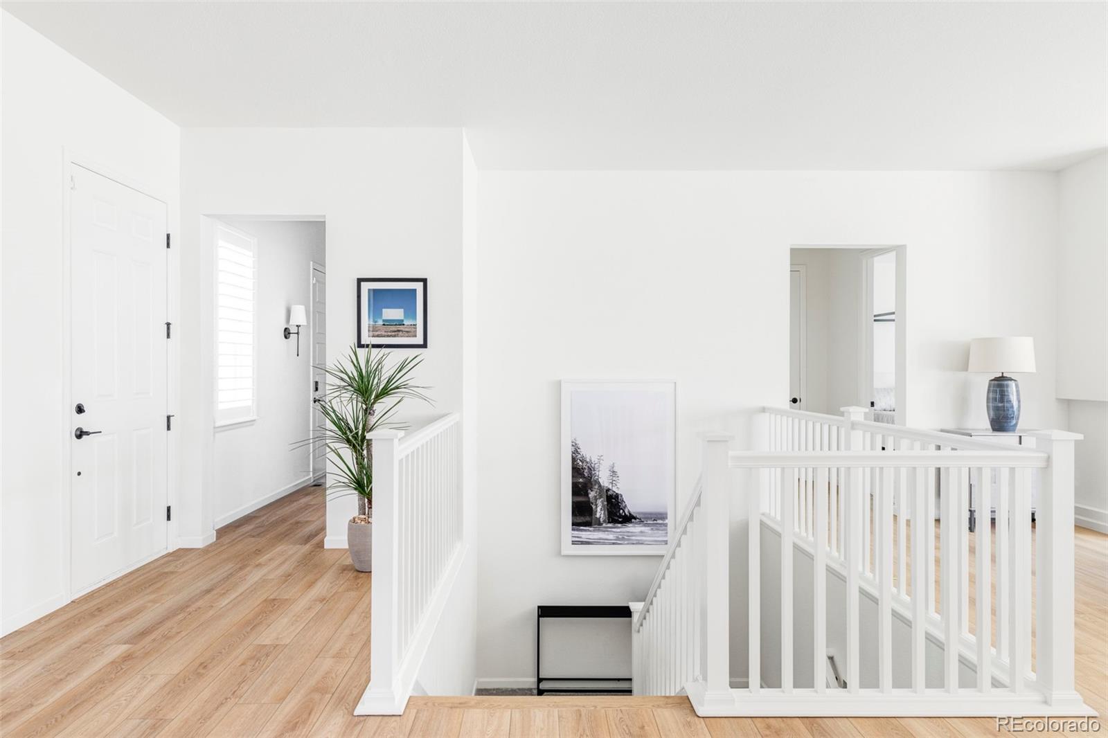14395 Hop Clover Street Parker, CO 80134 - Photo 21 of 32 a view of entryway with wooden floor